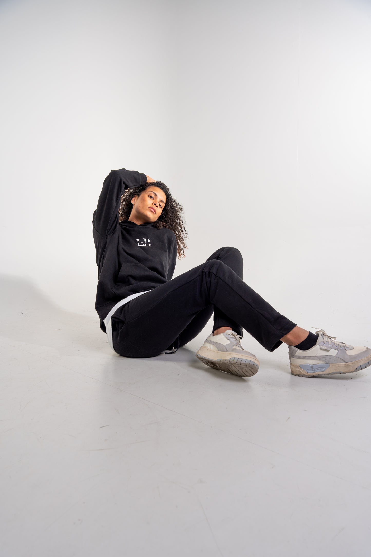 Female model wearing the Black ocean tracksuit and the Arctic Pearl T-shirt